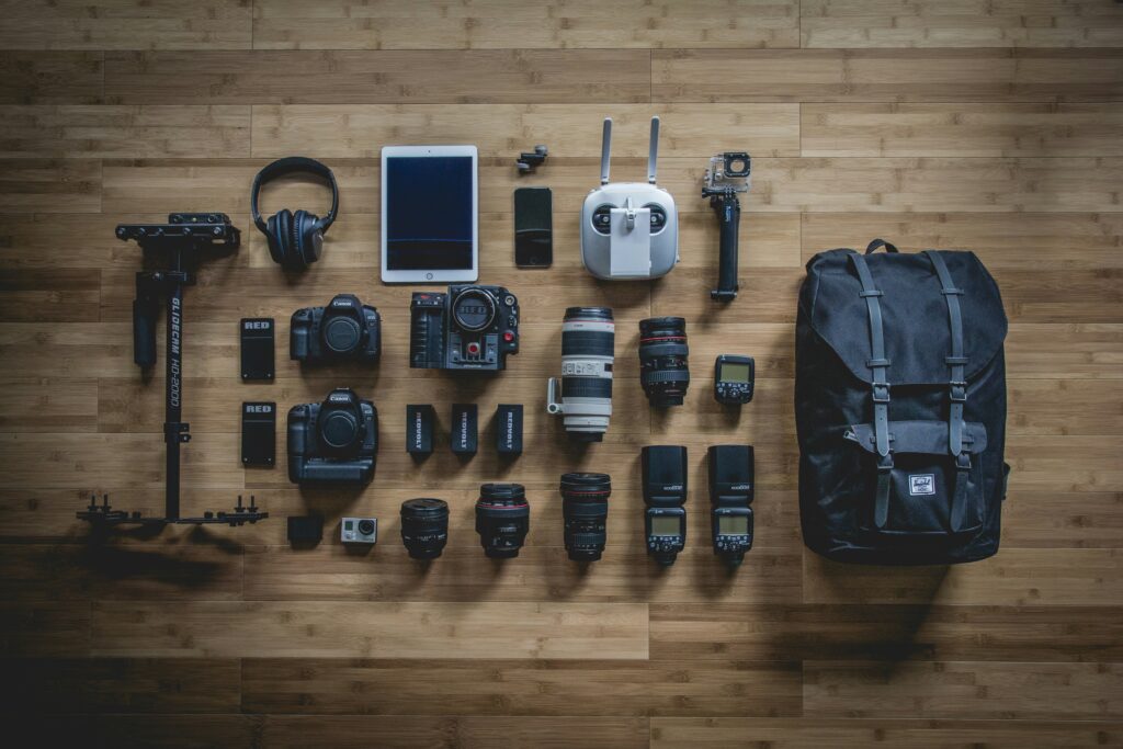 Camera lenses and camera equipment laid out for a luxury photographic safari