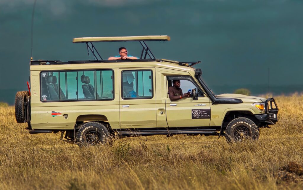 Professional Masai Mara safari guide Mike from Afrikan Accent Adventures tracking wildlife and reading the landscape in the Mara North Conservancy, Kenya.