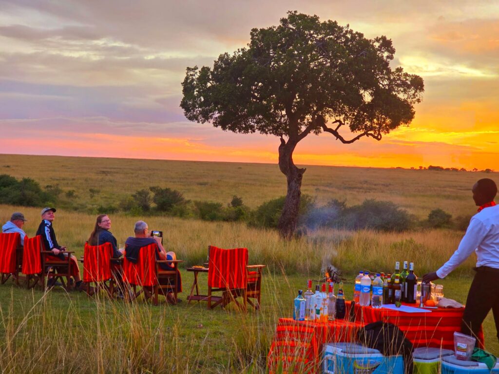 Afrikan Accent Adventures clients enjoying a sundowner cocktail in Masai Mara after their safari