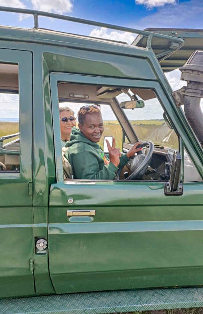 Female safari guide Magdaline Muindi behind the wheel on a Masai Mara game drive