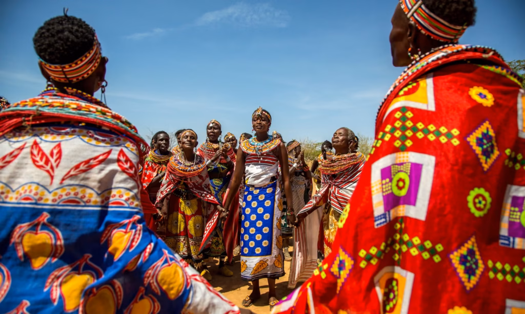 Samburu women dressed in vibrant traditional attire gathered at Umoja Uaso village in a Northern Kenya safari guide
