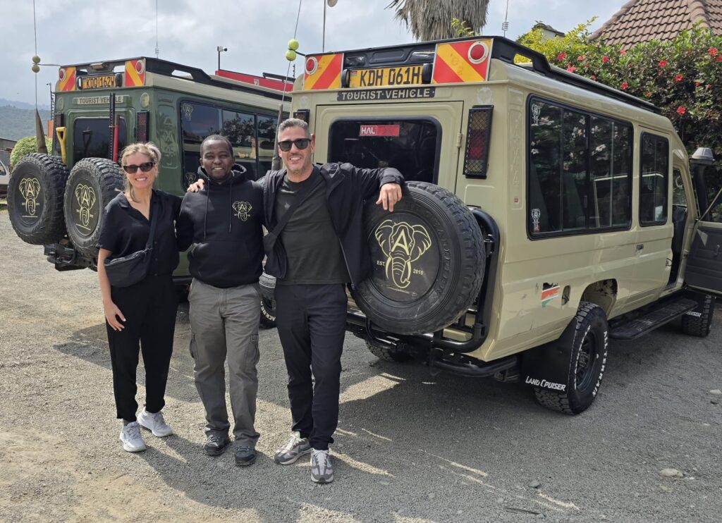 Founder Nicholas Wangithi welcoming clients beside Afrikan Accent Adventures 4x4 safari vehicles