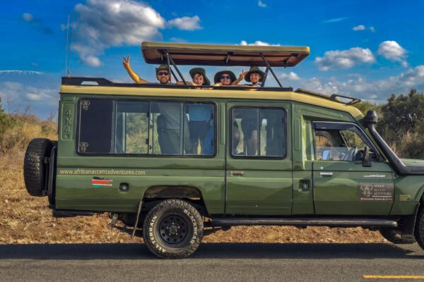 Guests enjoying a book a seat safari Kenya in an Afrikan Accent Adventures 4x4 Land Cruiser