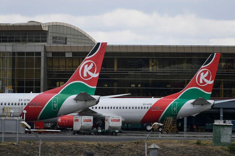 Kenya Airways commercial aircraft parked outside the international terminal building following a JKIA arrival in Nairobi.
