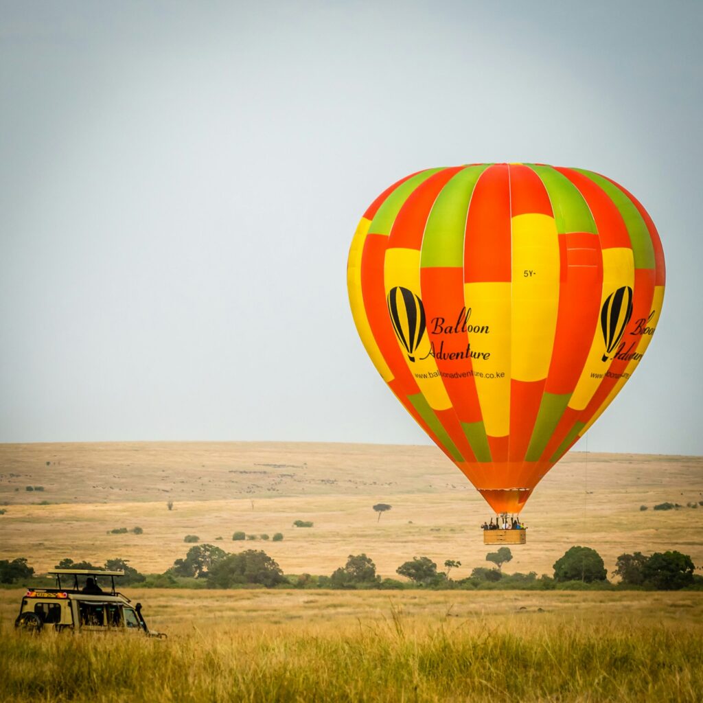 Hot air balloon safari over the Masai Mara at sunrise, an activity requiring specific cover on Kenya safari travel insurance